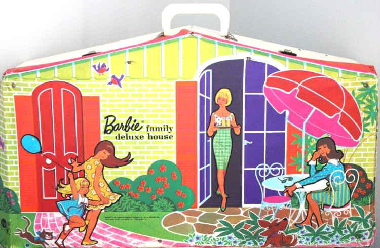 Barbie Family Deluxe House exterior bearing illustration showing a yellow brick house with two pairs of doors: arched, louvered red doors with rectangular shutters to either side, and arched glass doors. Skipper, Tutti and cat cavort on a brick path leading to the red doors. Through the glass doors walks Barbie, holding a tray of drinks, onto a fieldstone pation on which Francie sits at a white circular table with umbrella and two wrought iron chairs. Greenery surrounds them. A dog sits close to Francie in the extreme foreground.