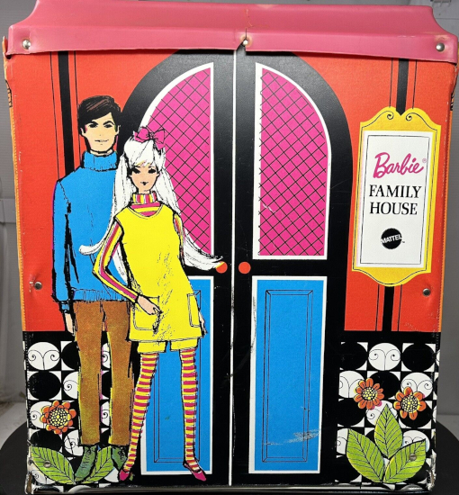 Color photo of vinyl case home exterior with flat pink plastic roof. On the side facing the camera, an arched double door is printed. To one side of the door a placard reads "Barbie Family House (Mattel)" and to the other side Barbie and Ken pose facing the viewer. This scene resembles a couple before their new home, along with the word "family," suggesting certain things about Barbie and Ken's relationship at this point in time.