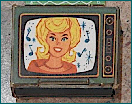 Very close up image of greenish chipboard set. Smiling blonde woman with wide reddish collar, red beaded necklace, and bouffant/flip hairstyle appears on "screen" surrounded by music notes and asterisks.